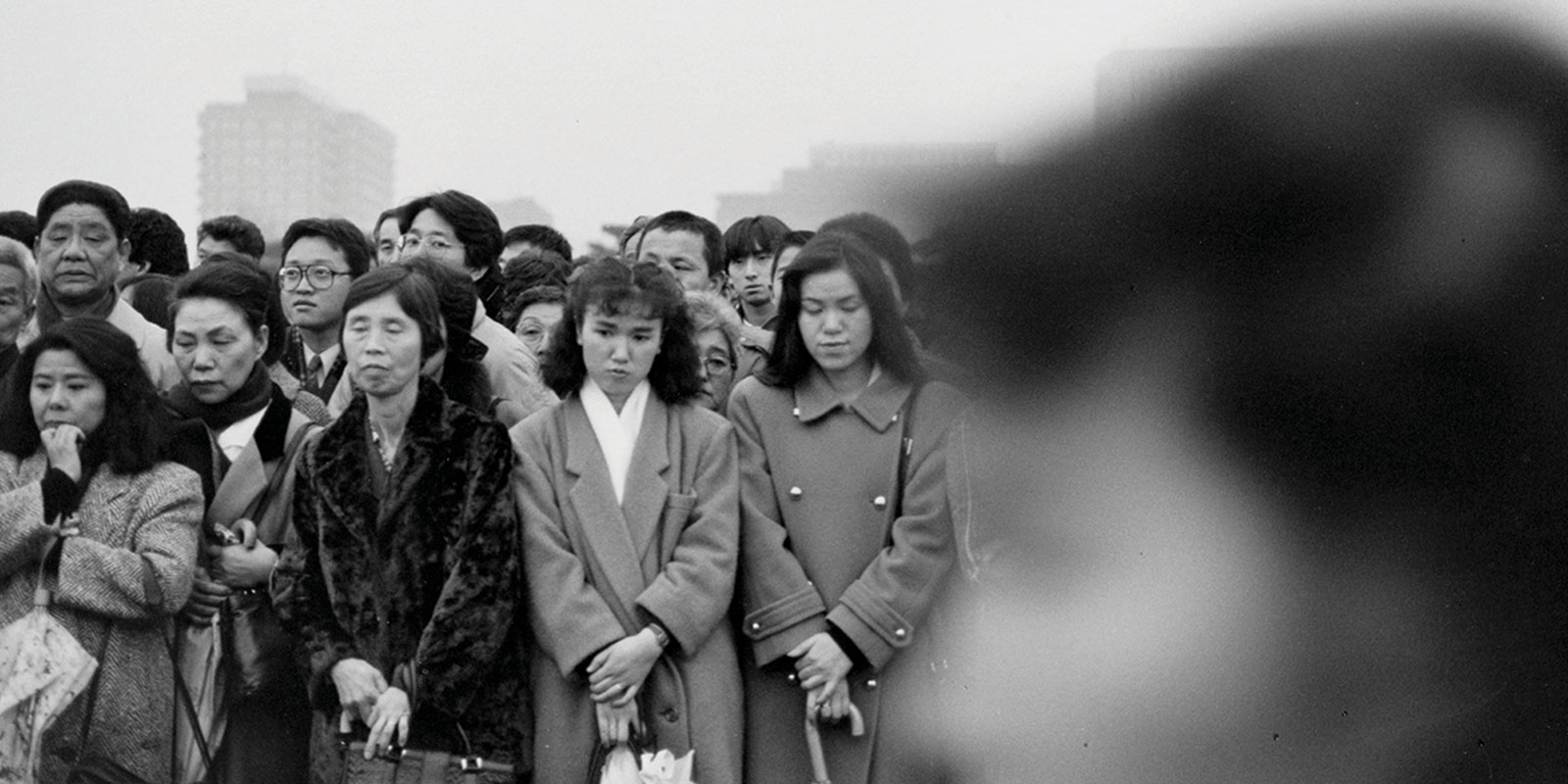 Mourners gather at Tokyo’s Imperial Palace on the day of the state funeral of Emperor Hirohito, 1989