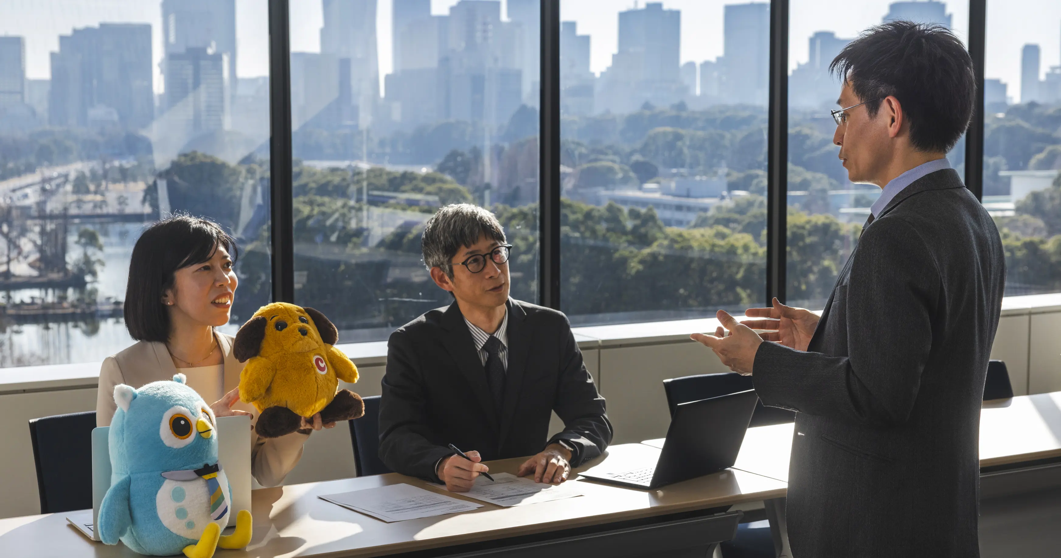 Digital Agency Director Hiroyuki Kato and team members discuss Japan's Customs and Immigration mascots
